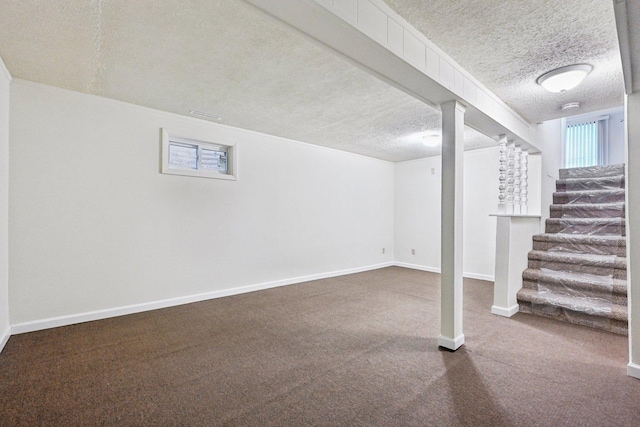 basement with carpet and a textured ceiling