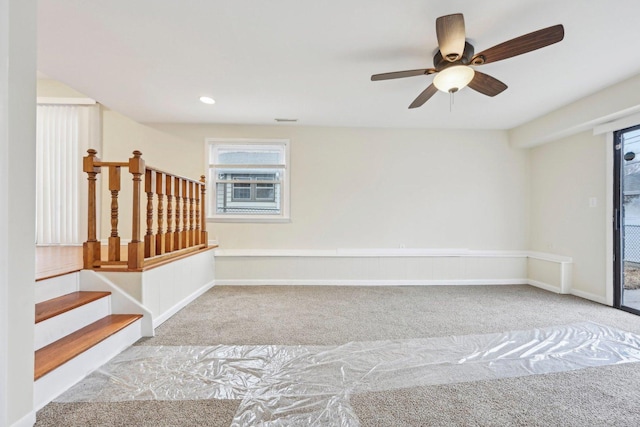 interior space featuring light colored carpet and ceiling fan