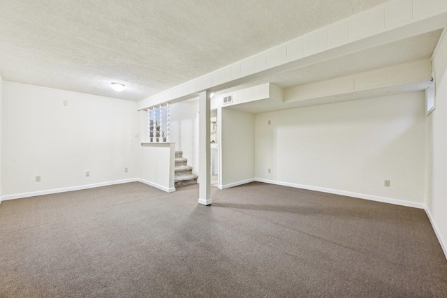 basement featuring carpet floors and a textured ceiling