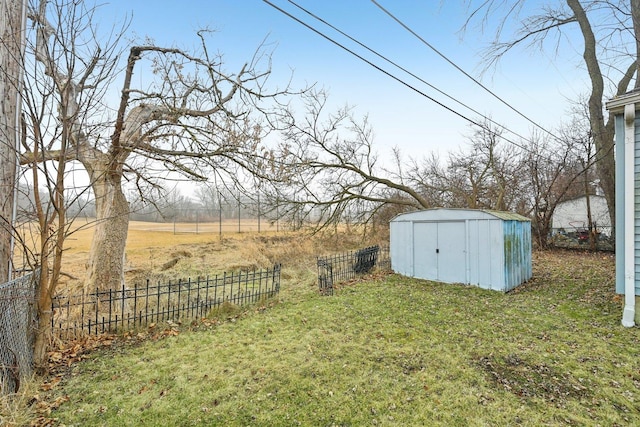 view of yard with a rural view and a storage shed