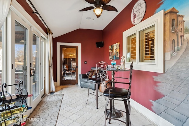 sunroom featuring vaulted ceiling and ceiling fan