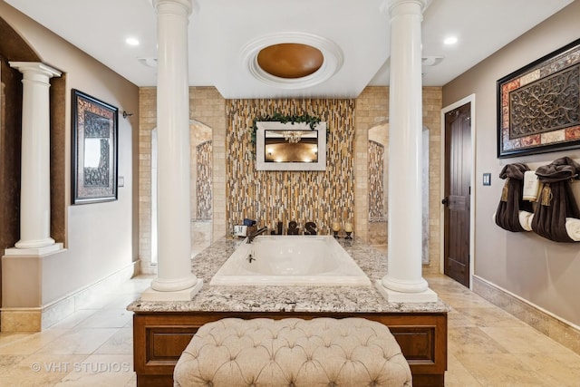 full bathroom with baseboards, recessed lighting, a bath, and ornate columns