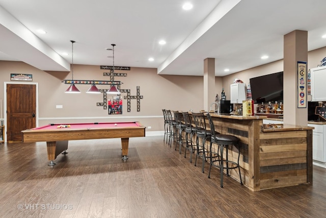 playroom with dark wood-style floors, recessed lighting, and a bar