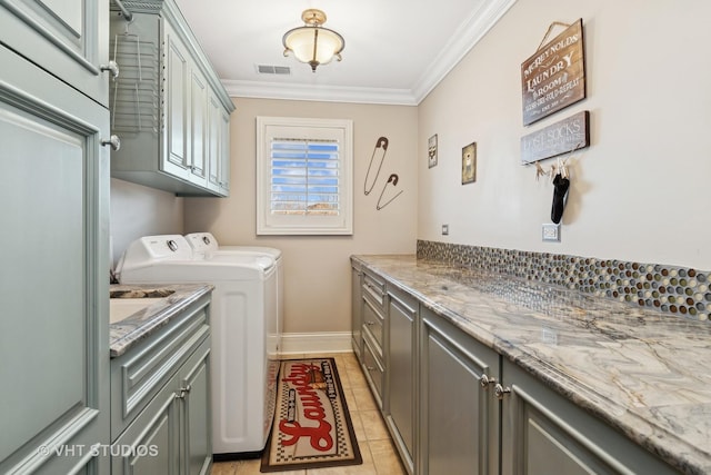 laundry area featuring cabinet space, baseboards, visible vents, washer and clothes dryer, and ornamental molding