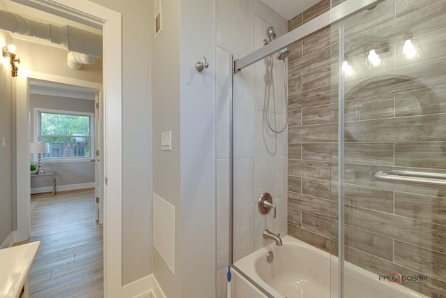 bathroom with vanity and shower / bath combination with glass door