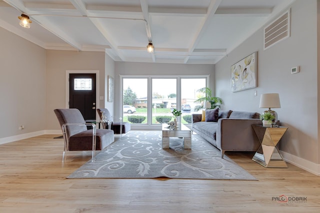 living room with beam ceiling, plenty of natural light, coffered ceiling, and light hardwood / wood-style floors