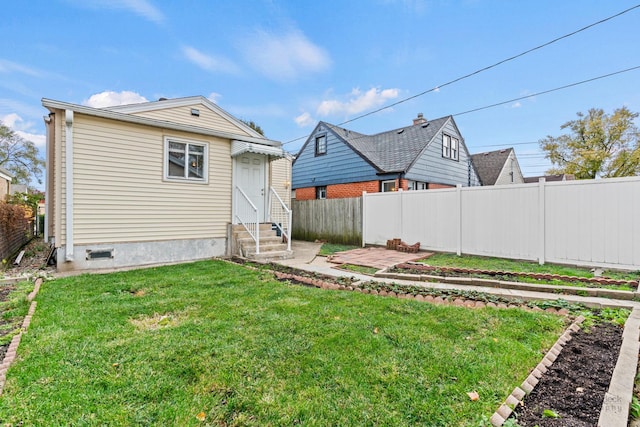 rear view of house with a patio and a lawn