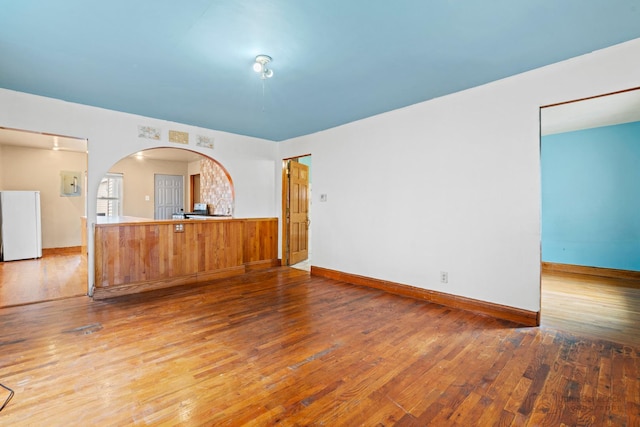 unfurnished living room featuring hardwood / wood-style flooring