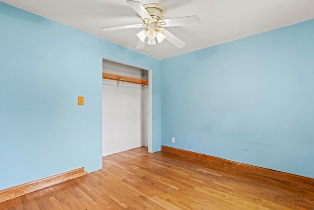 unfurnished bedroom featuring ceiling fan, light hardwood / wood-style floors, and a closet