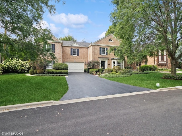 view of front facade with a garage and a front yard