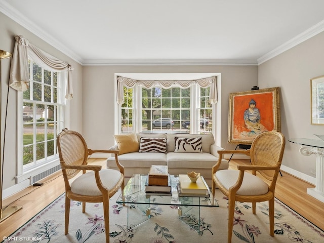 sitting room with wood-type flooring and ornamental molding