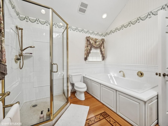 bathroom with toilet, wood-type flooring, shower with separate bathtub, and vaulted ceiling