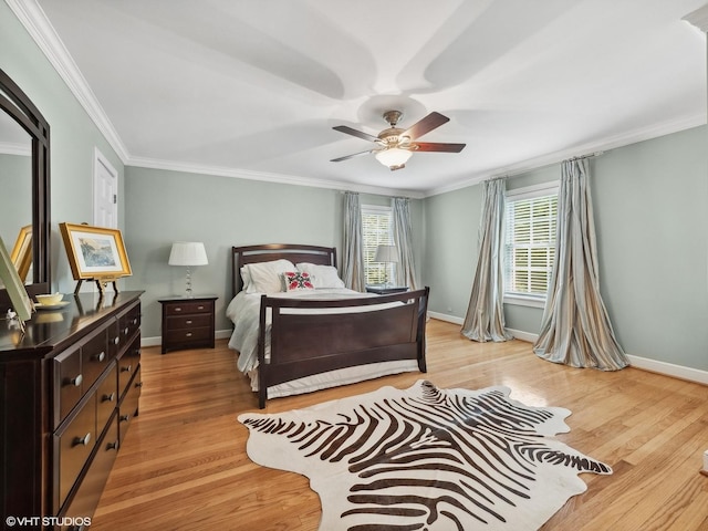 bedroom featuring crown molding, ceiling fan, and light hardwood / wood-style flooring