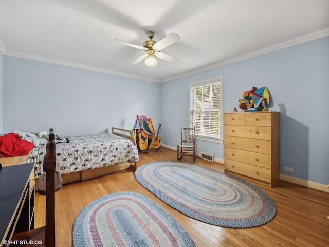 bedroom with ceiling fan, ornamental molding, and wood-type flooring