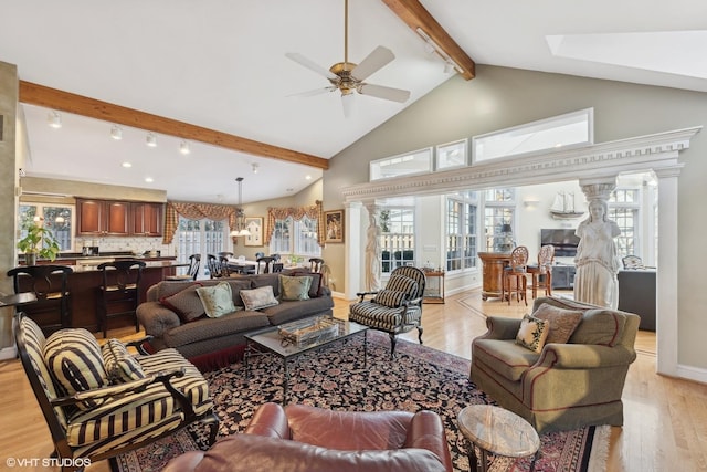 living room featuring ceiling fan, high vaulted ceiling, light hardwood / wood-style floors, and beamed ceiling