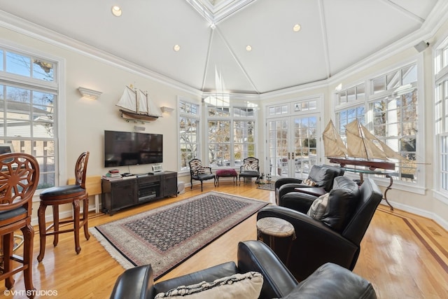 living room with crown molding, light hardwood / wood-style flooring, high vaulted ceiling, and french doors