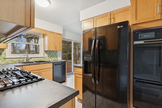 kitchen with light brown cabinets, sink, decorative backsplash, and black appliances