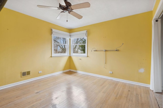 empty room with ceiling fan and light hardwood / wood-style floors