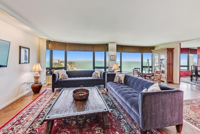 living room with a water view and parquet flooring