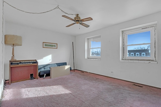 carpeted home office with ceiling fan