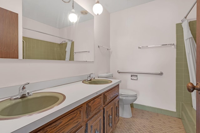 full bathroom with tile patterned flooring, vanity, shower / tub combo, and toilet