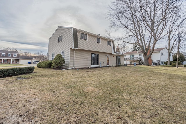 rear view of house with a lawn