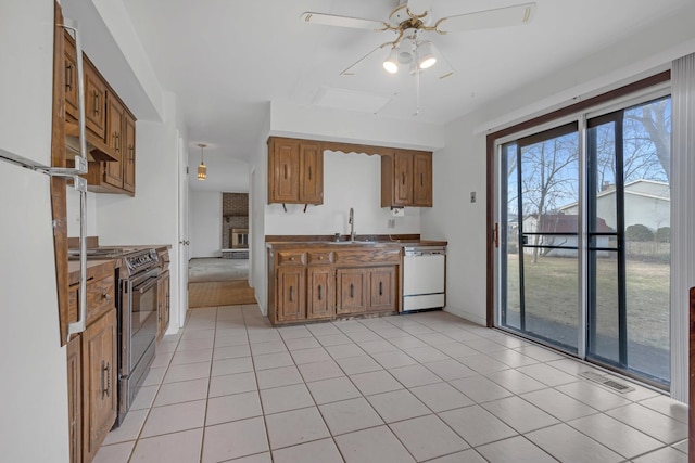 kitchen featuring sink, white appliances, light tile patterned floors, and ceiling fan