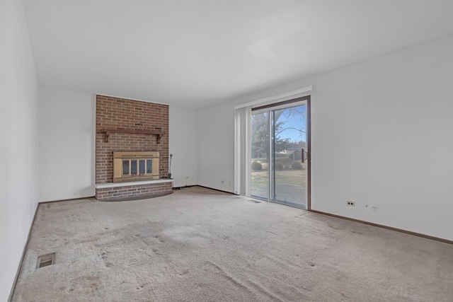 unfurnished living room featuring carpet flooring and a fireplace