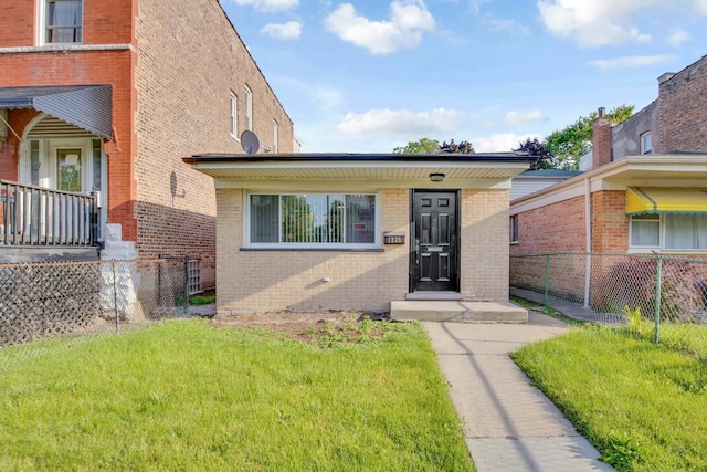 view of exterior entry with a lawn