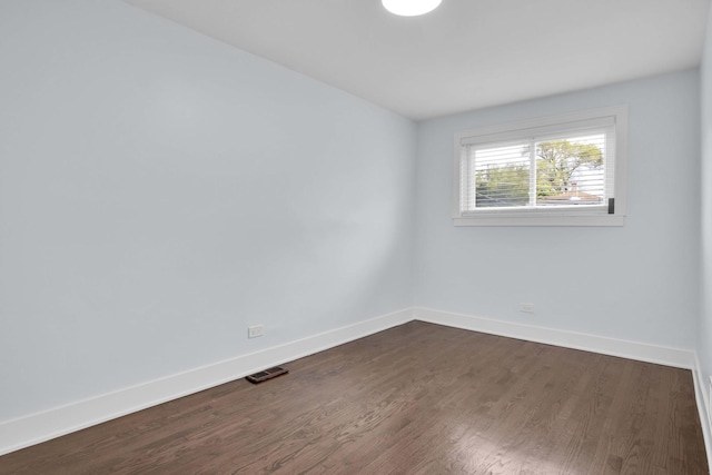 spare room with dark hardwood / wood-style floors