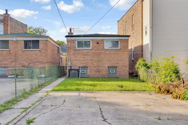 rear view of house with a yard