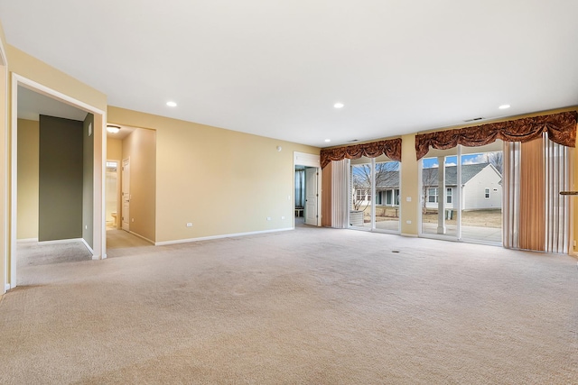 unfurnished living room with light colored carpet