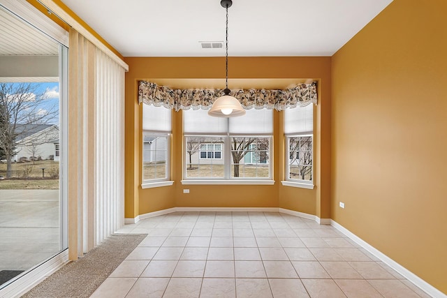 unfurnished dining area featuring tile patterned floors