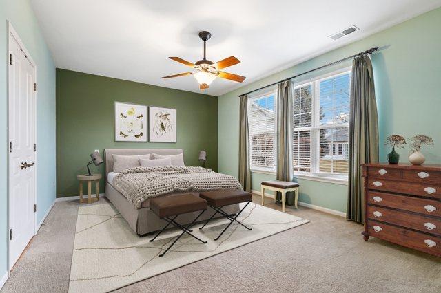 bedroom featuring light colored carpet and ceiling fan