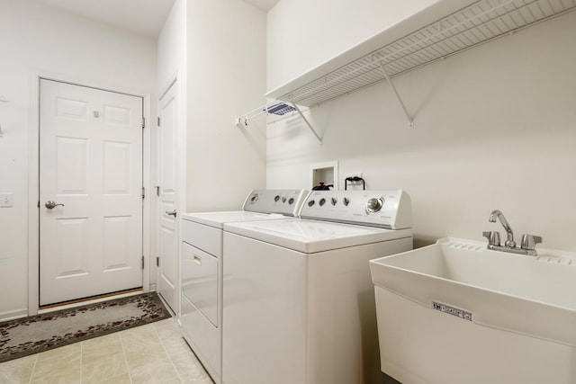 clothes washing area featuring washer and dryer, sink, and light tile patterned floors