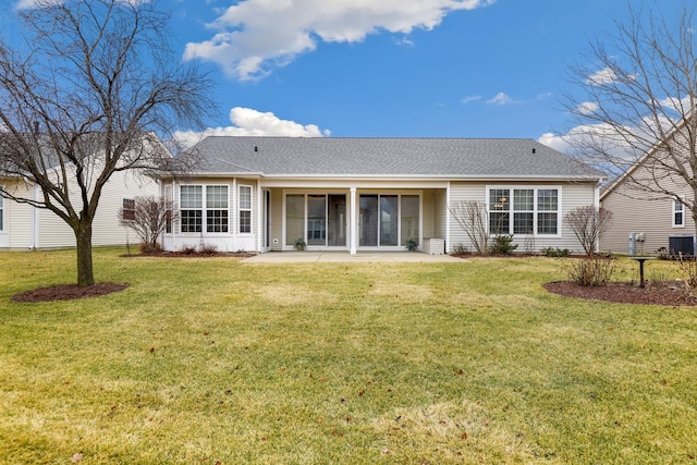 rear view of property with a patio and a lawn