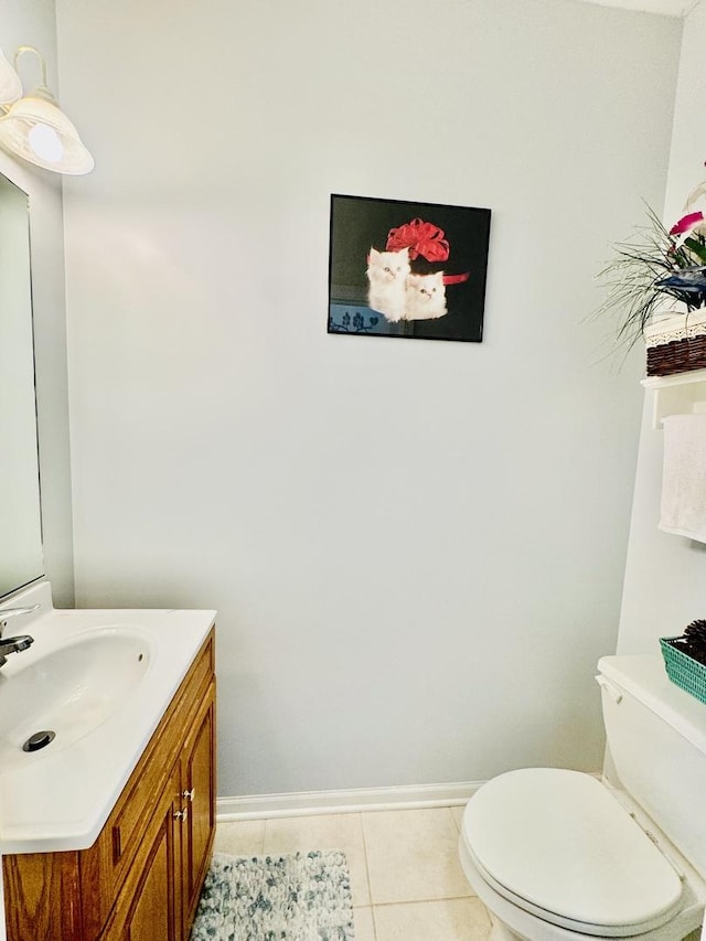 bathroom with tile patterned floors, vanity, and toilet