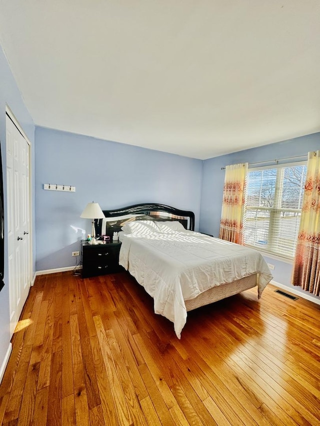 bedroom featuring hardwood / wood-style floors and a closet