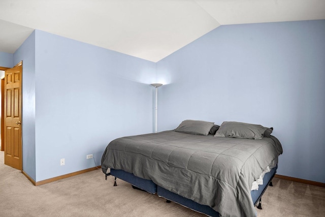 carpeted bedroom featuring lofted ceiling