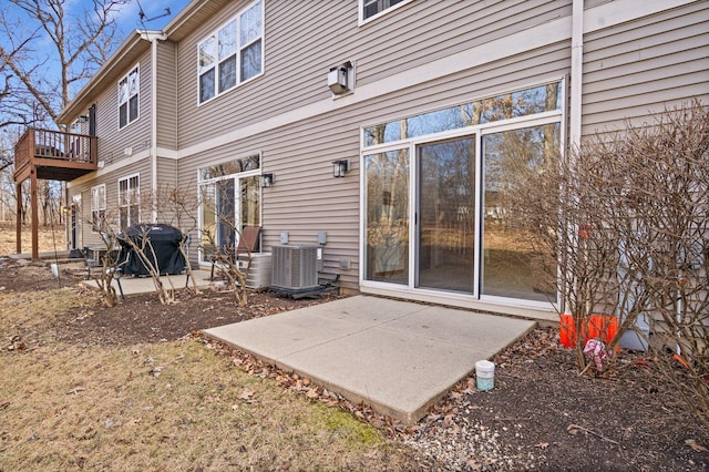 rear view of house featuring central AC unit and a patio area