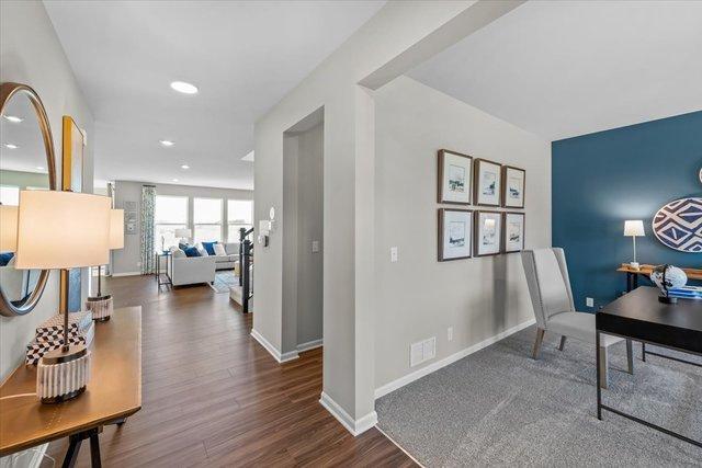 home office with dark hardwood / wood-style floors