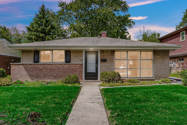 view of front of home with a yard