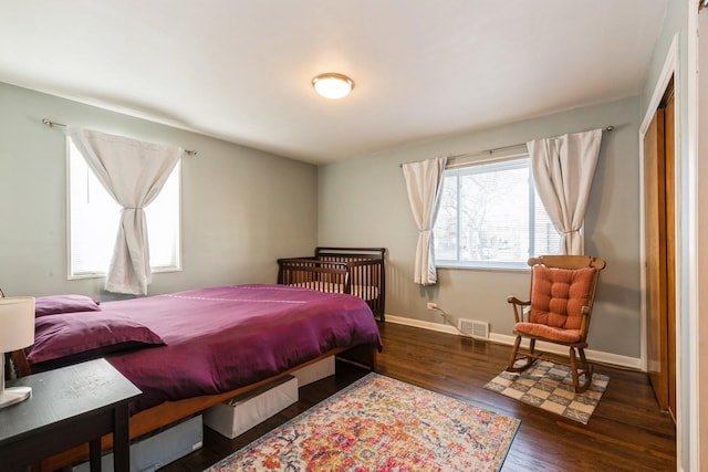 bedroom with dark hardwood / wood-style floors