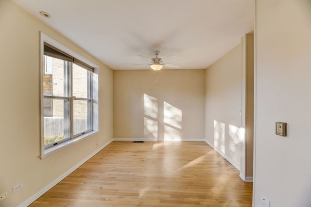 empty room with ceiling fan and light wood-type flooring