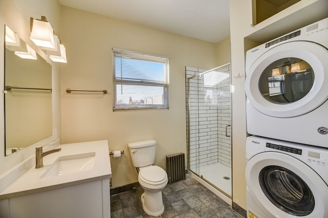 bathroom with radiator, stacked washer and dryer, vanity, walk in shower, and toilet