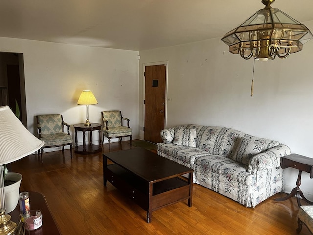 living room with a notable chandelier and hardwood / wood-style flooring