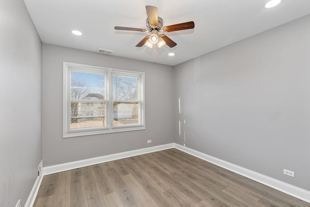 spare room featuring hardwood / wood-style flooring and ceiling fan