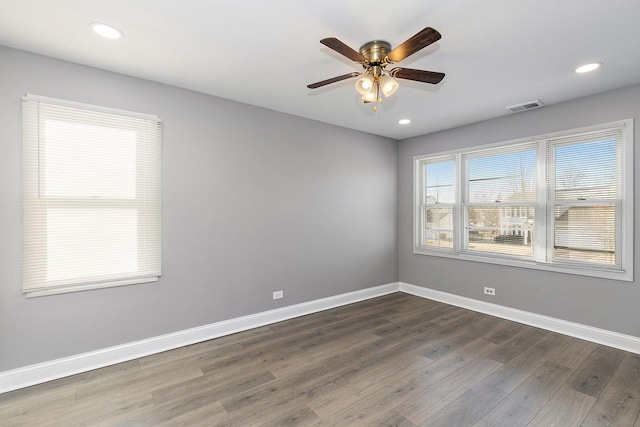 spare room with ceiling fan and dark hardwood / wood-style flooring