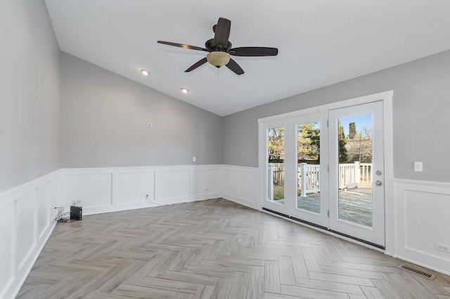 unfurnished room with light parquet flooring, lofted ceiling, and ceiling fan