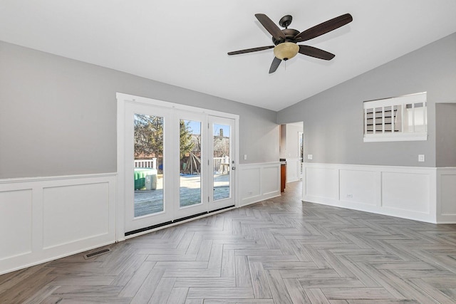 spare room featuring ceiling fan, vaulted ceiling, and light parquet floors